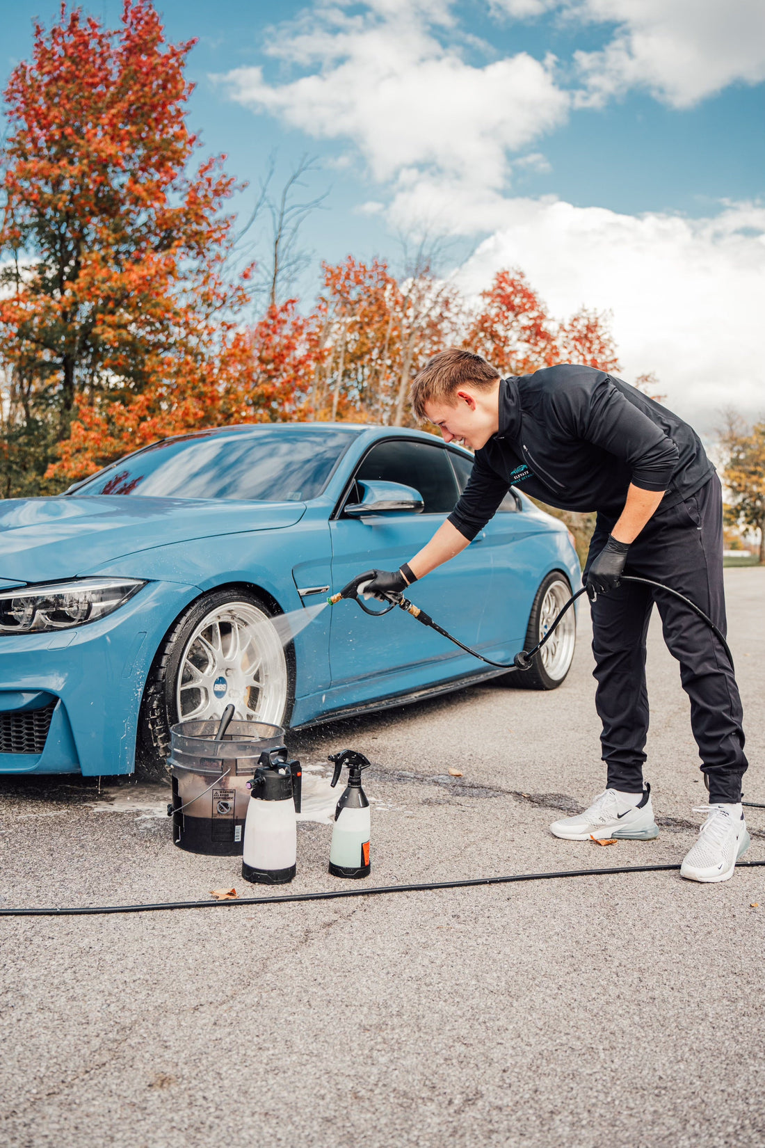 Professional detailer cleaning wheels of BMW M4