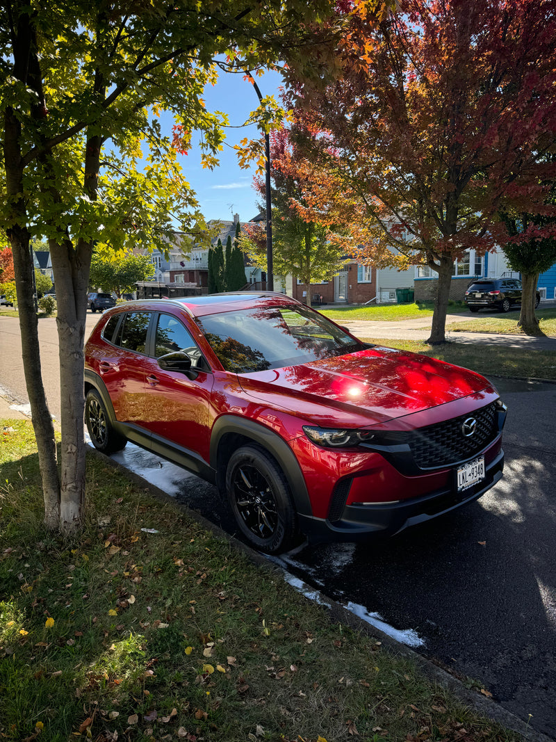 Red Mazda after exterior detail on public road